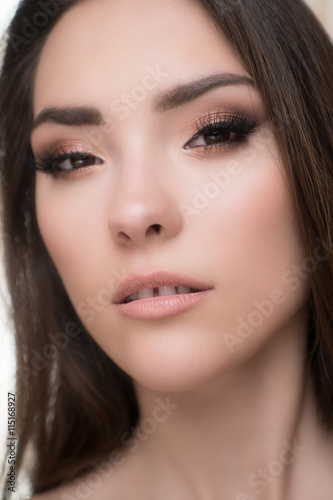 Closeup of beautiful brunette woman with pretty eyes and gap between teeth 