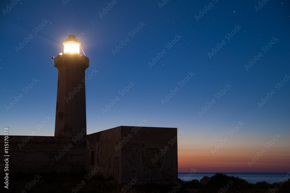 The lighthouse of Syracuse before the dawn against a starry sky
