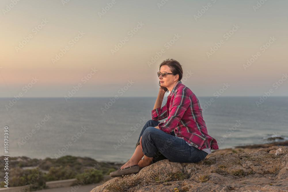 Woman watching sunset. Mediterranean, Spain.
