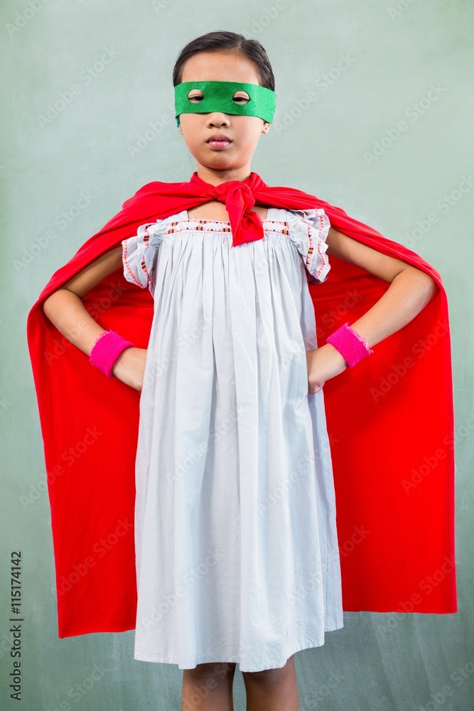 Girl dressed as superhero in classroom