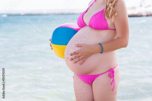 Pregnant woman with ball on the beach © _chupacabra_