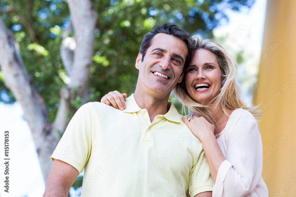 Fototapeta premium Happy couple standing against tree
