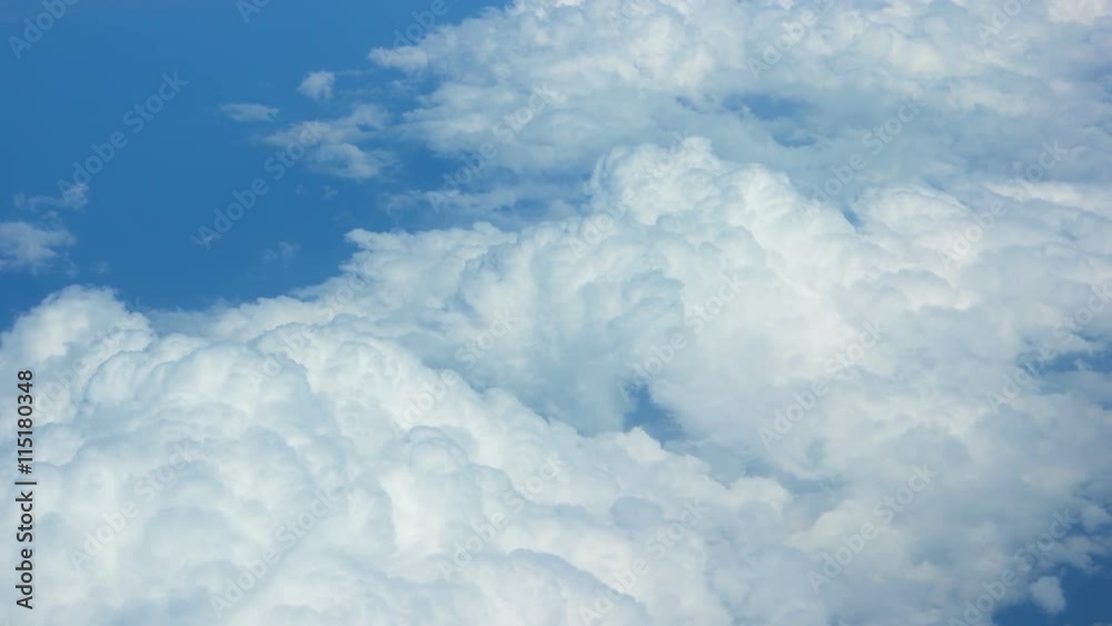 Big, soft, puffy clouds on a bold, blue sky, drifting below, from an airborne perspective. Video UltraHD Big, soft, puffy clouds on a bold, blue sky, drifting below, from an airborne perspective. Video UltraHD