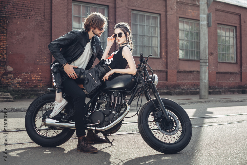 Couple in love and vintage custom motorcycle