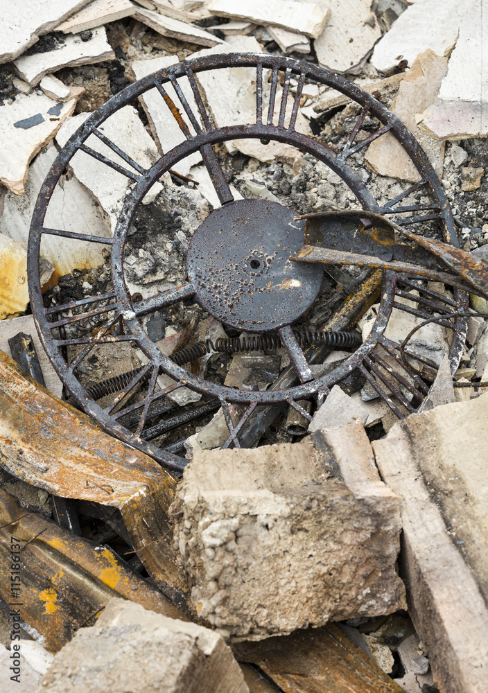 Destroyed personal property after a house fire. Clock in ruins of burned home after a natural disaster wildfire.
