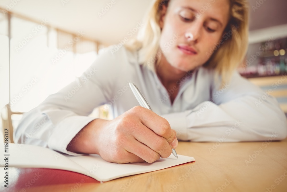 Man writing on a book Man writing on a book