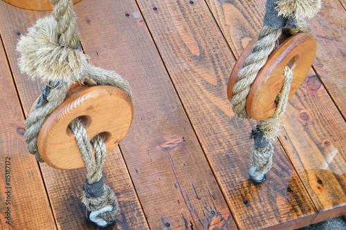 Wooden Pulleys with Frayed Rope photo