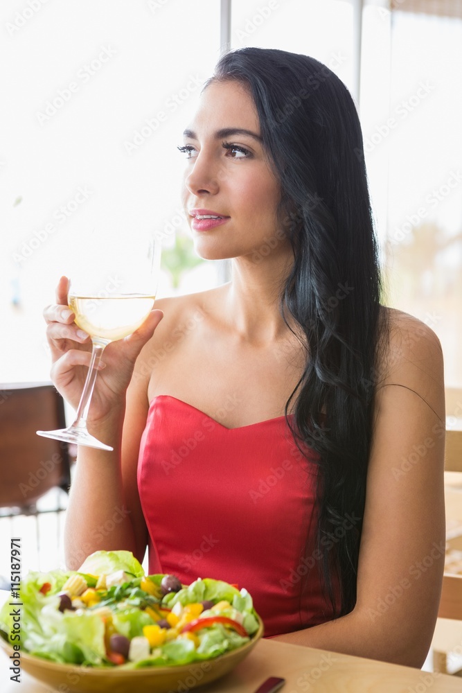Beautiful woman having champagne with food salad Beautiful woman having champagne with food salad