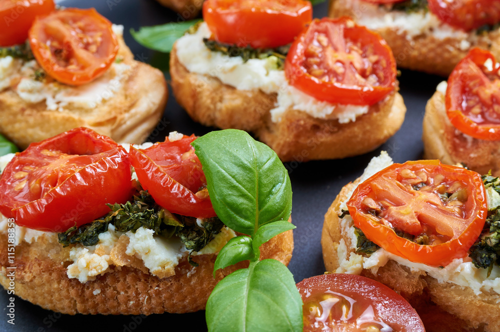 Bruschetta with roasted tomatoes, feta cheese and home made pest Bruschetta with roasted tomatoes, feta cheese and home made pest