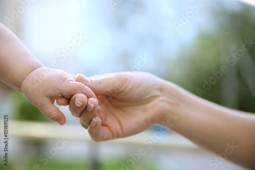 Child holding mother hand © Africa Studio