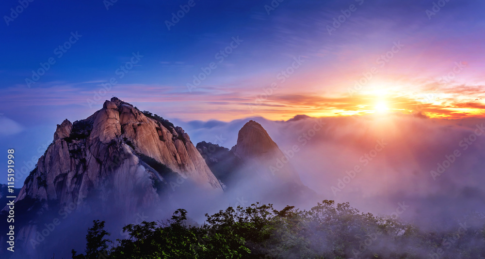 Bukhansan mountains is covered by morning fog and sunrise in Seo
