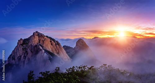 Bukhansan mountains is covered by morning fog and sunrise in Seo