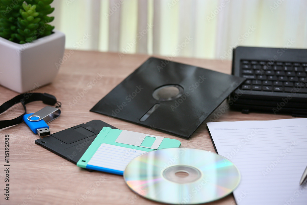 desk with note ,floppy disk A, floppy disk B and memory drive in home office, private office and modern desk in modern life, online market and planning for work, document and paper on desk. desk with note ,floppy disk A, floppy disk B and memory drive in home office, private office and modern desk in modern life, online market and planning for work, document and paper on desk.