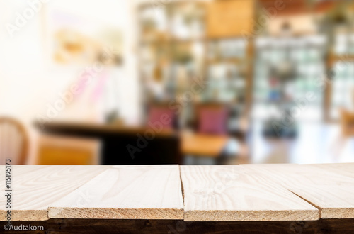 Selected focus empty brown wooden table and Coffee shop blur bac