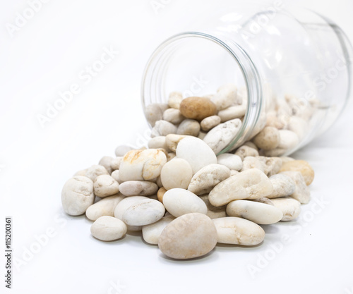Canned pebble. Glass jar with sea pebbles isolated on white bacground.