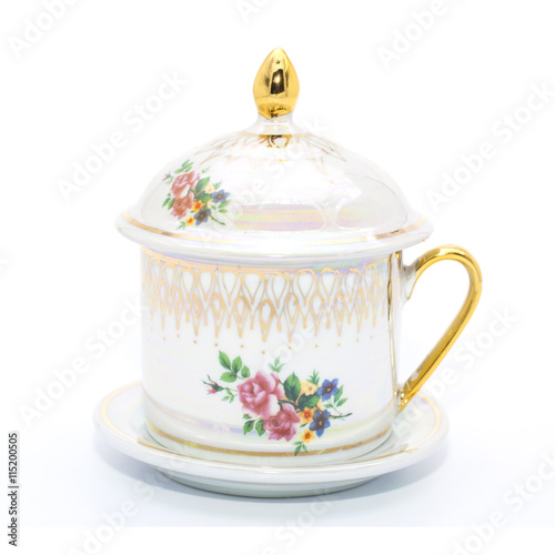 Antique porcelain tea cup on white background