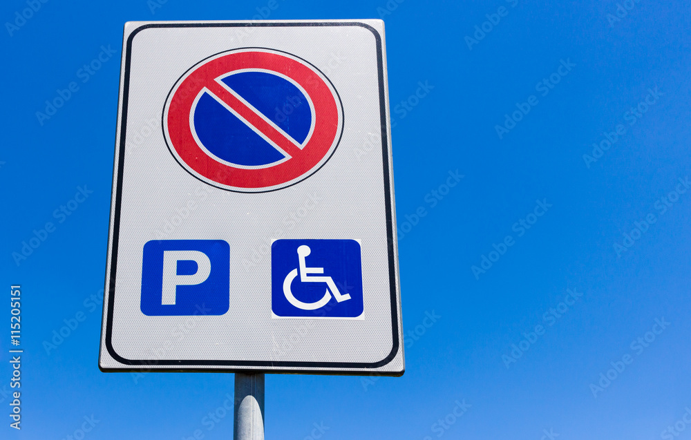 Road sign no parking, except for wearers handicap.