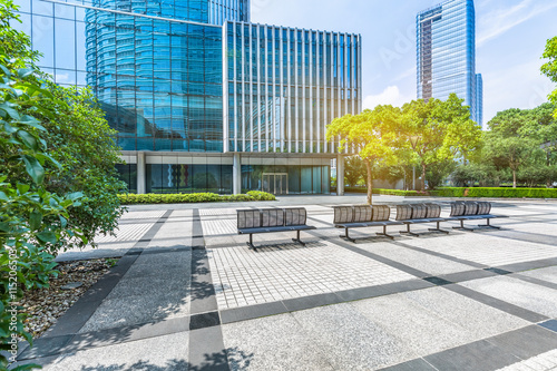 empty pavement and modern buildings in city photo