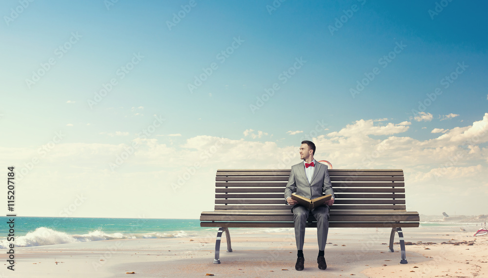 Businessman reading old book . Mixed media Businessman reading old book . Mixed media