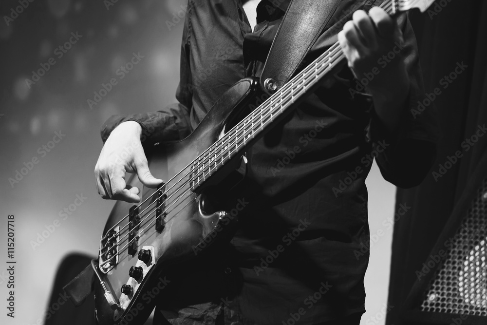 Fototapeta premium Rock and roll music, bass guitar player closeup