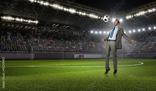 Businessman kicking ball . Mixed media © Sergey Nivens