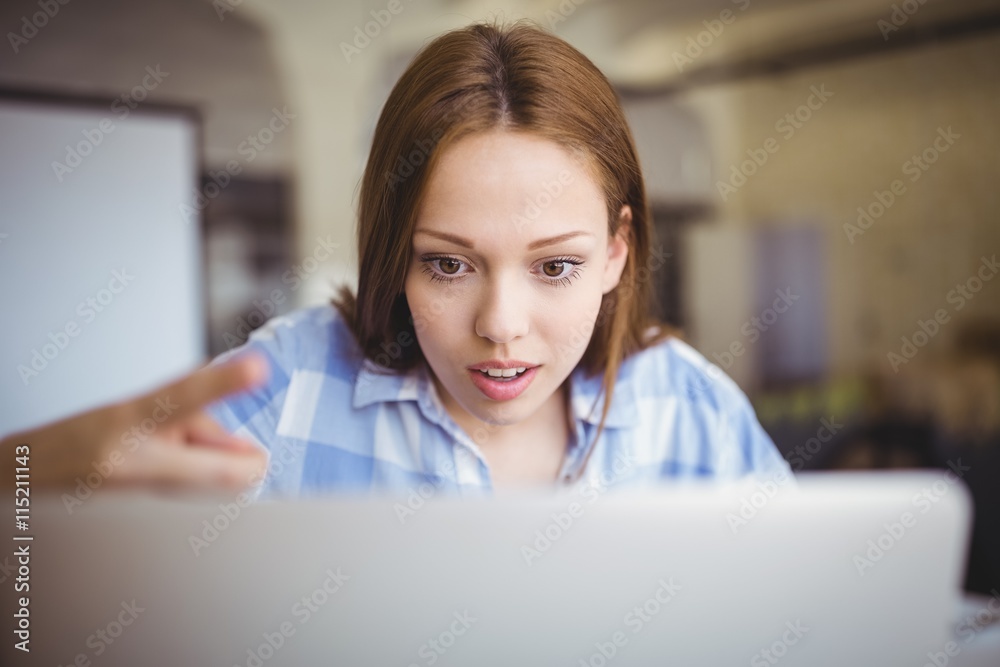 Surprised businesswoman working on laptop in office Surprised businesswoman working on laptop in office