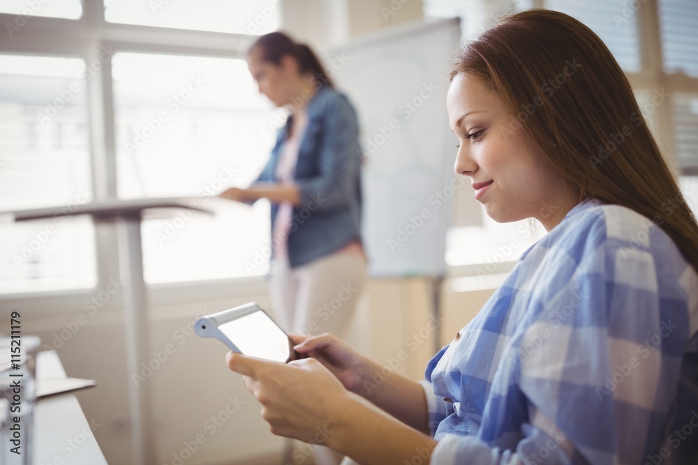 Businesswoman using digital tablet at creative office Businesswoman using digital tablet at creative office
