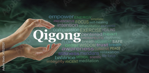 Qigong word cloud and healing hands - female cupped hands with the word QIGONG between surrounded by word cloud on a flowing green light and dark background photo