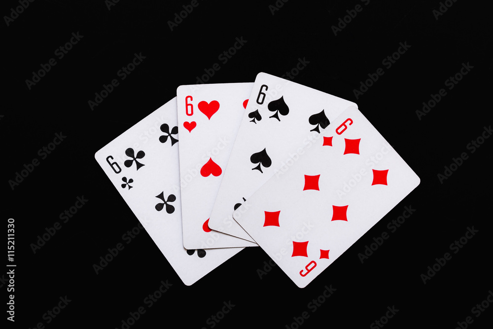 playing cards of four sixes on a black background