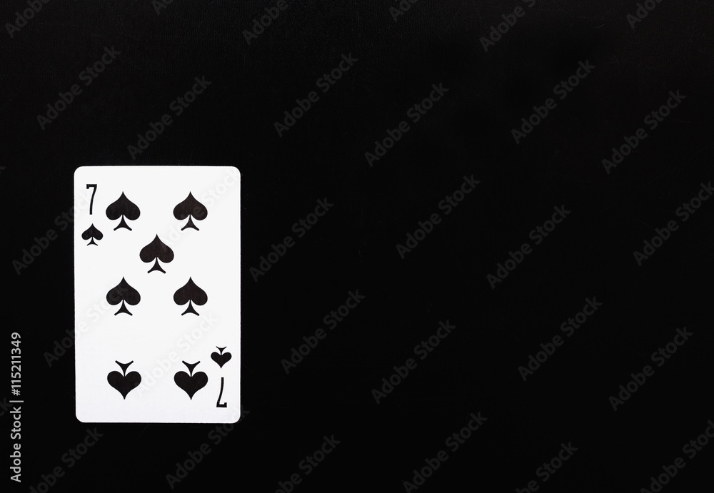Playing card. playing card seven peak on a black background