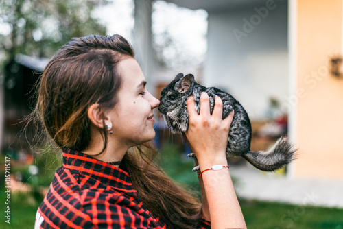 girl playing with her chinchilla photo