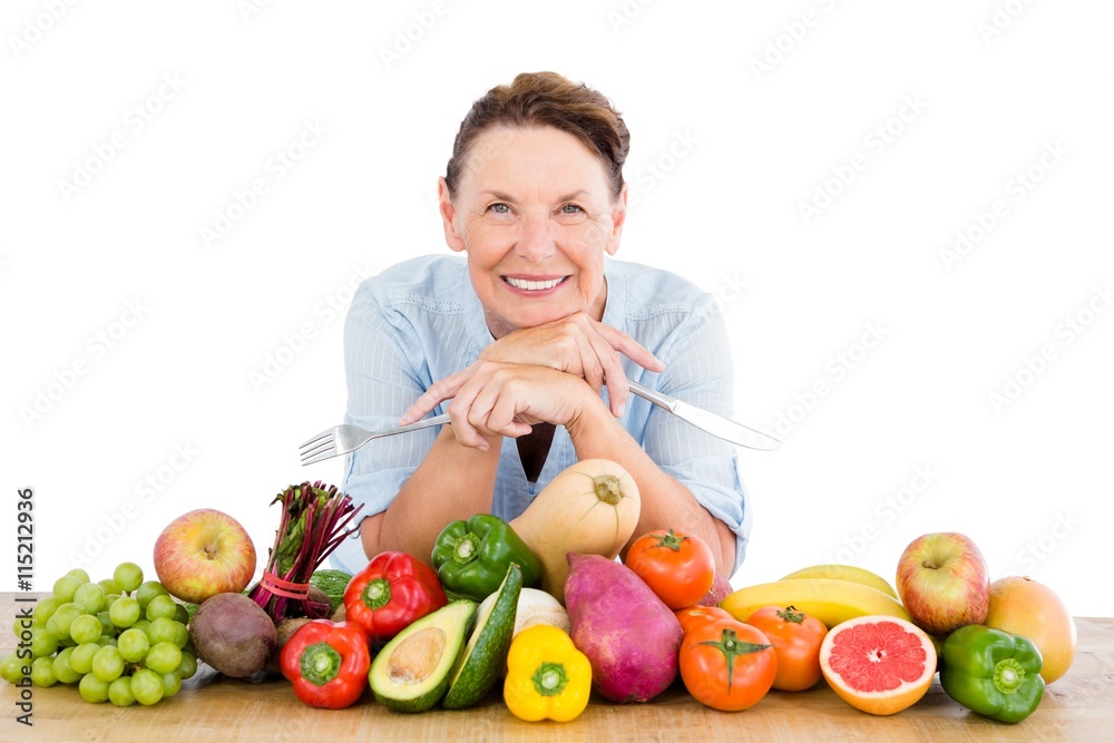 Portrait of smiling woman with fruits and vegetables at table Portrait of smiling woman with fruits and vegetables at table