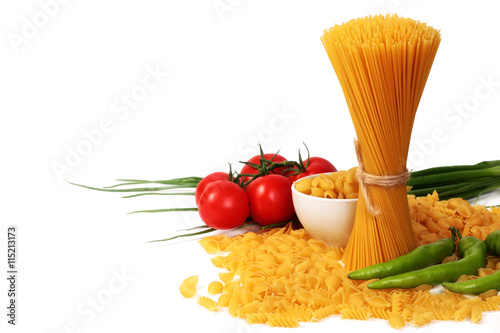 different types of raw italian pasta with vegetables and spices isolated on white background close up