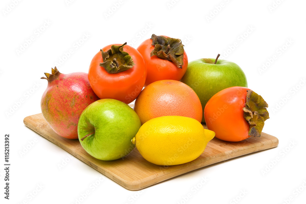 ripe fruit on a wooden cutting board closeup on white background ripe fruit on a wooden cutting board closeup on white background