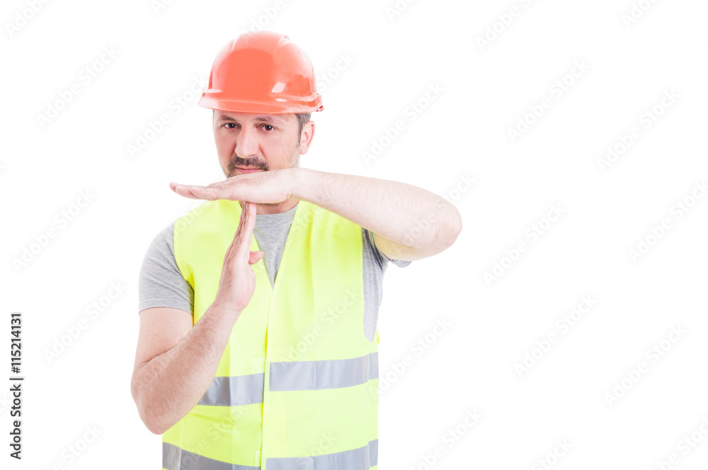 Young handsome constructor doing time out gesture