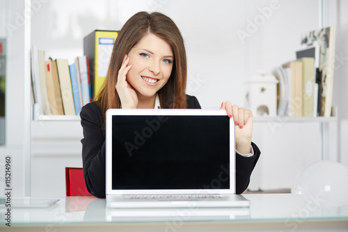 Business woman with a laptop showing something on the screen