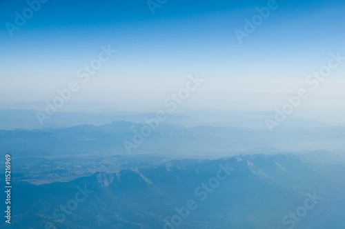 View from the airplane on the sky and clouds. White clouds against blue sky with copy space for background design 