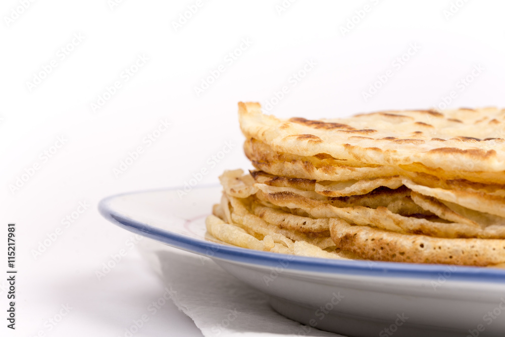 Homemade pancakes on the plate. Isolated on white background. Homemade pancakes on the plate. Isolated on white background.