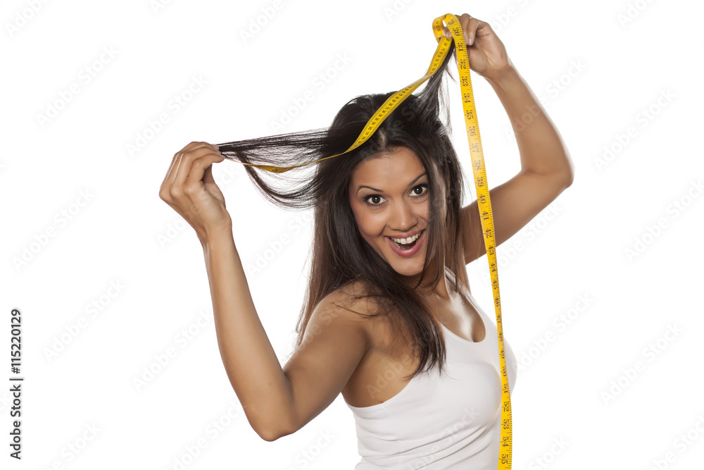Φωτογραφία young happy woman shows the length of her hair