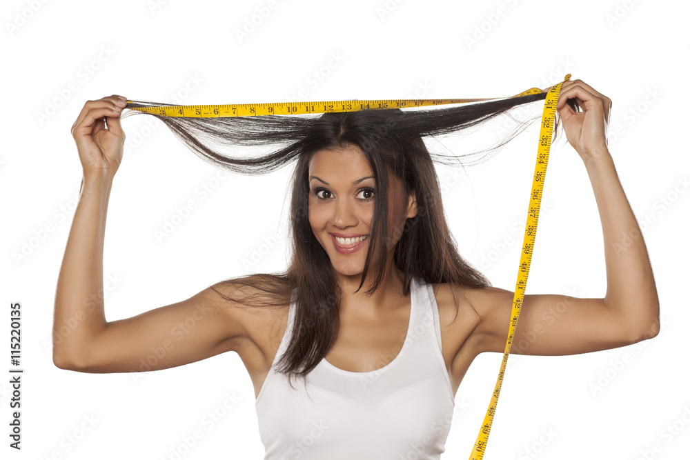 Φωτογραφία young happy woman shows the length of her hair
