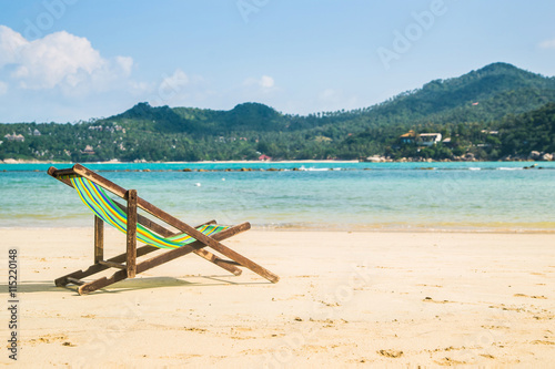 Lounge chairs on a tropical beach at summer.