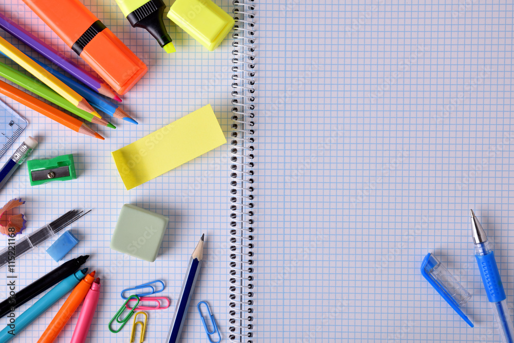 Open notebook in center close up with school material Open notebook in center close up with school material