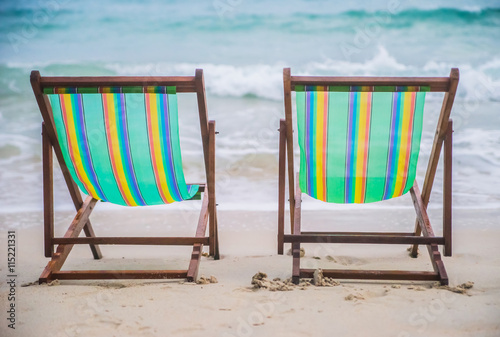 Lounge chairs on a tropical beach at summer.