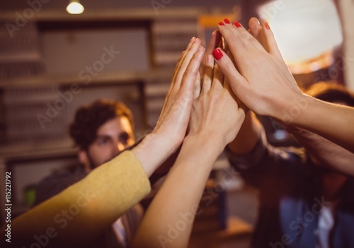 Colleagues giving high five at office