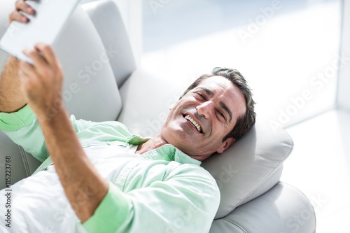 Man holding digital tablet at home