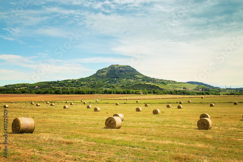 Hay bales on the field with  mountainin the background in Hungary photo