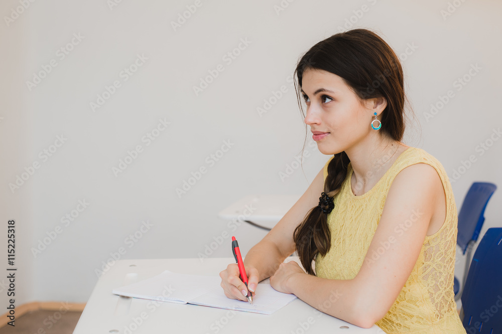 Female Teenage Student Studying In Classroom Female Teenage Student Studying In Classroom