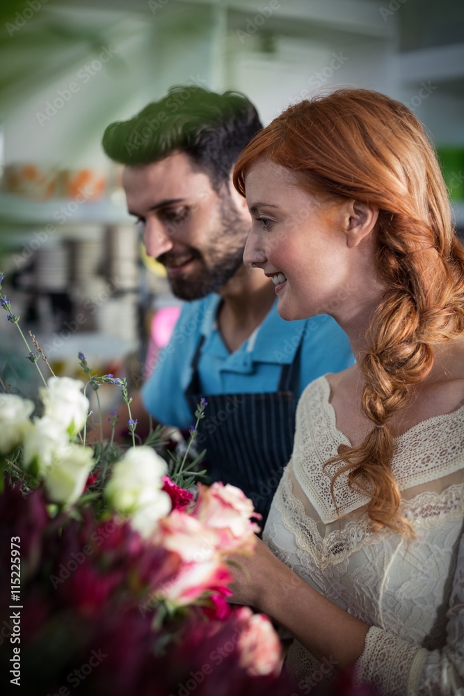 Happy couple arranging flowers Happy couple arranging flowers