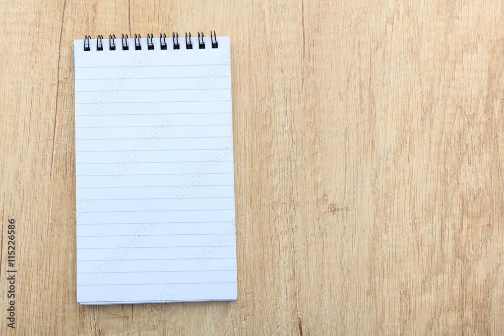 notepad on a wooden surface notepad on a wooden surface