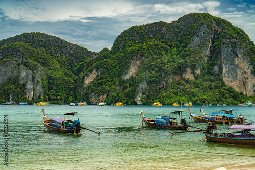 Traditional Thai Longtail boats and new speed boats on phi phi island , Thailand  © stryjek